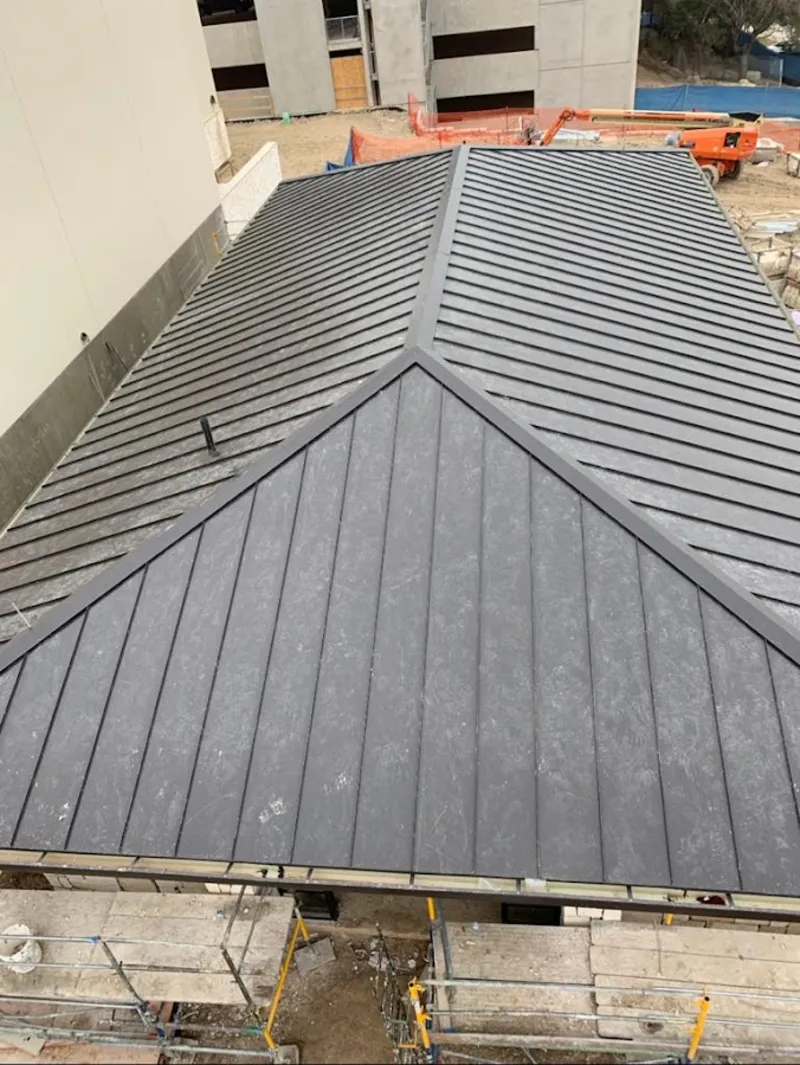 Commercial metal roof construction with crane equipment in Cherokee Village